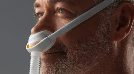 Close up of a man wearing the Fisher & Paykel Nasal CPAP Mask