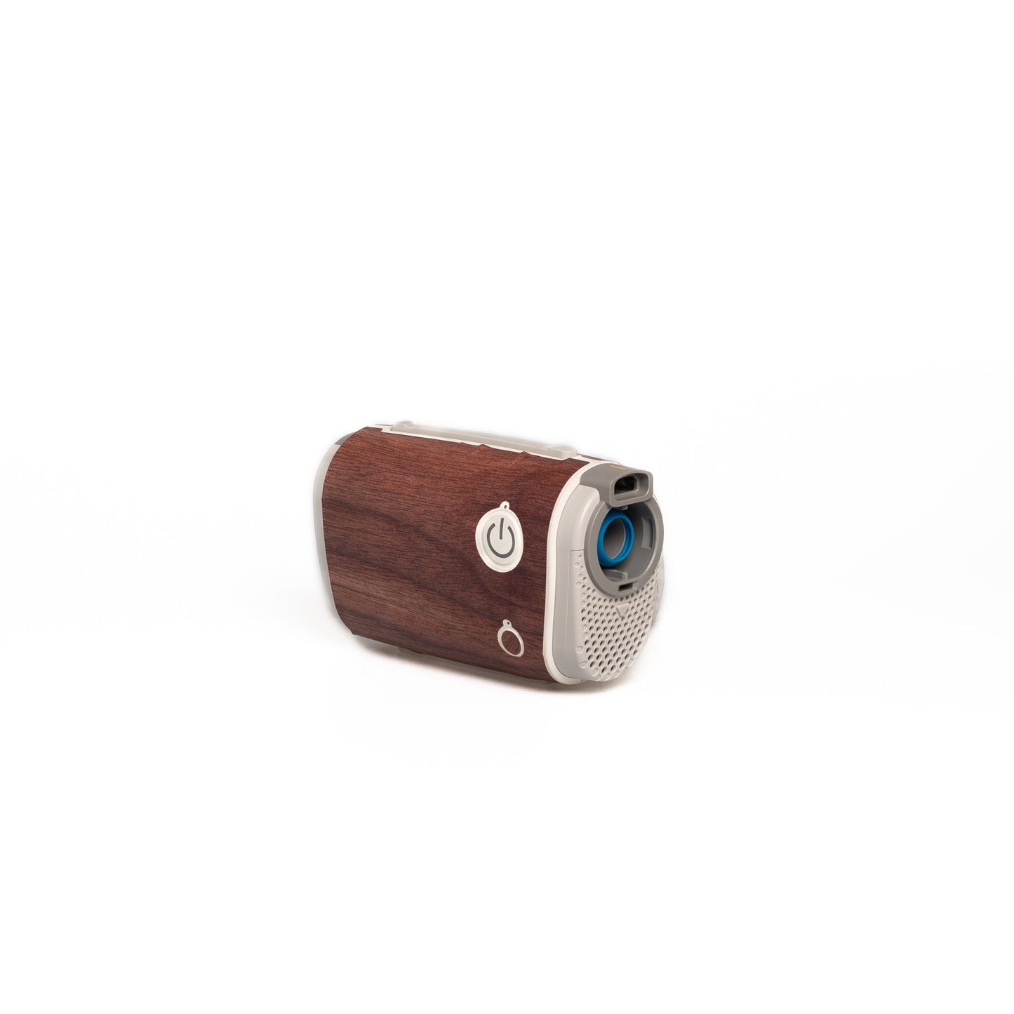 A close-up of an AirMini Travel CPAP machine wrapped in a sleek, wood-grain patterned skin by Snugell. This stylish cover adds a natural and warm aesthetic to the device, ideal for those who prefer a rustic or earthy look while traveling.