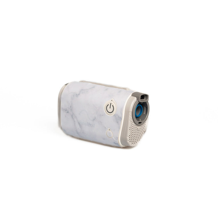 A chic, marble-patterned Snugell skin encases the AirMini Travel CPAP machine, adding an elegant, modern touch. The marble design is sleek and sophisticated, ideal for users who appreciate a luxurious appearance on their portable CPAP device.