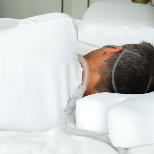 Man sleeping on CPAP Ergonomic Pillow