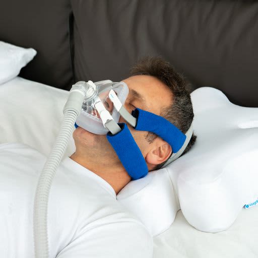 Man with cpap mask sleeping on CPAP Ergonomic Pillow