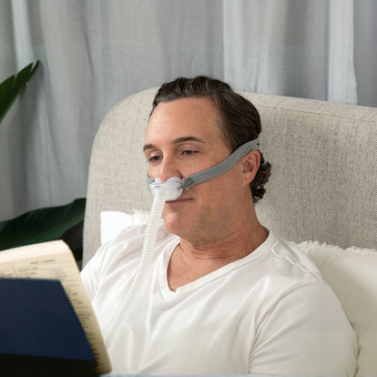 Man reading in bed wearing AirFit P10