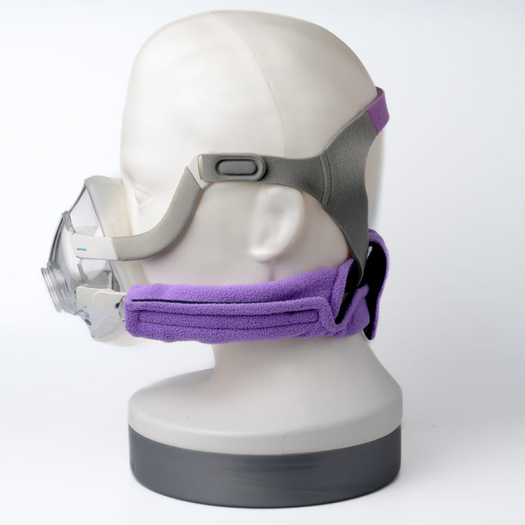 Side view of a mannequin wearing a CPAP mask with Snugell CPAP strap covers in purple, highlighting comfort features.