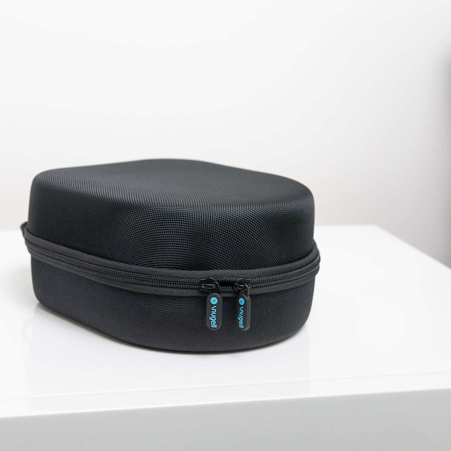 Closed Snugell CPAP Mask Storage Case on a white surface, showcasing a sleek, compact design for easy portability.